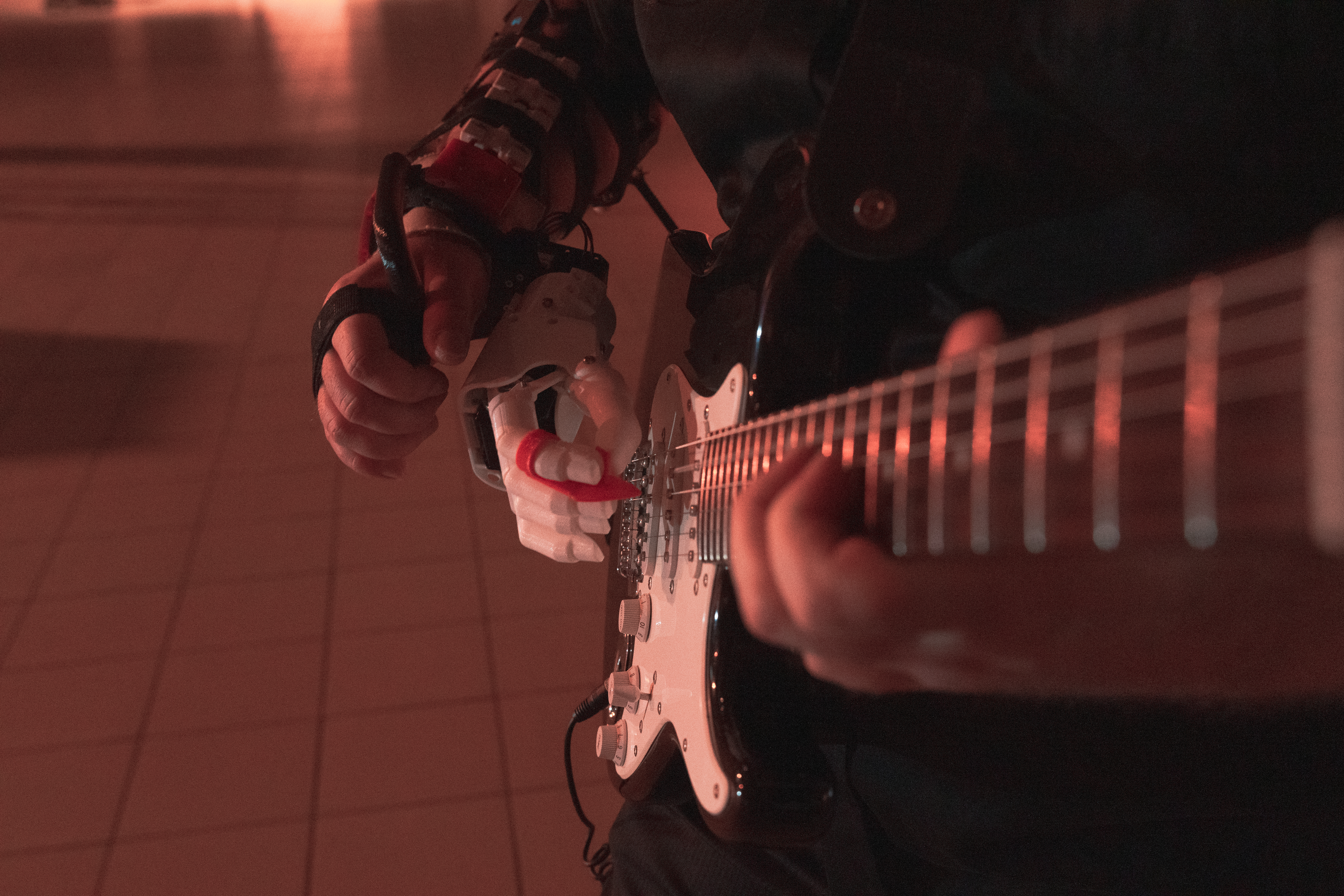 Glamor shot of the guitar neck and robot hand